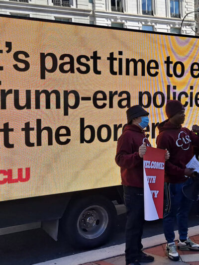 Billboard saying "It's past time to end the Trump-era policies at the border"
