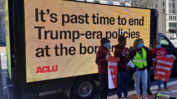 Billboard saying "It's past time to end the Trump-era policies at the border"