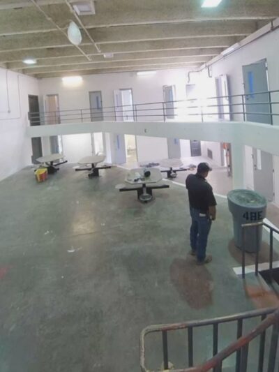 A prison guard watches as a person is assaulted in CNMCF.