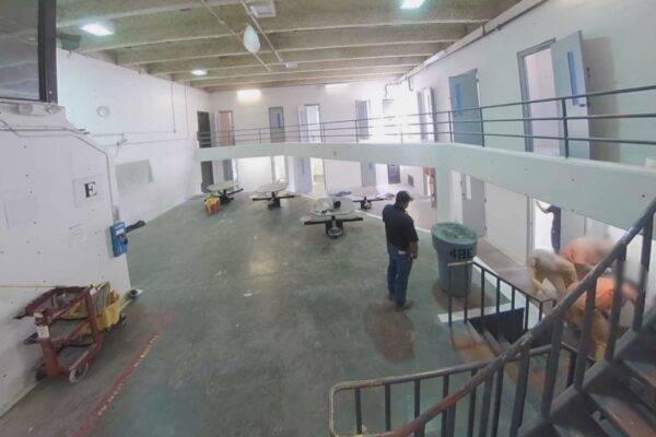 A prison guard watches as a person is assaulted in CNMCF.