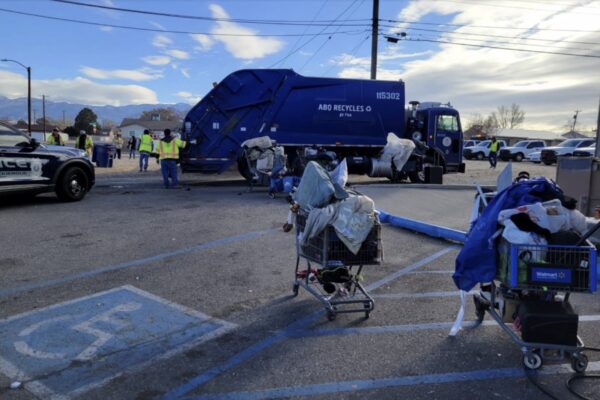 City workers remove the personal belongings of unhoused people in Albuquerque, which a judge recently ruled unconstitutional.
