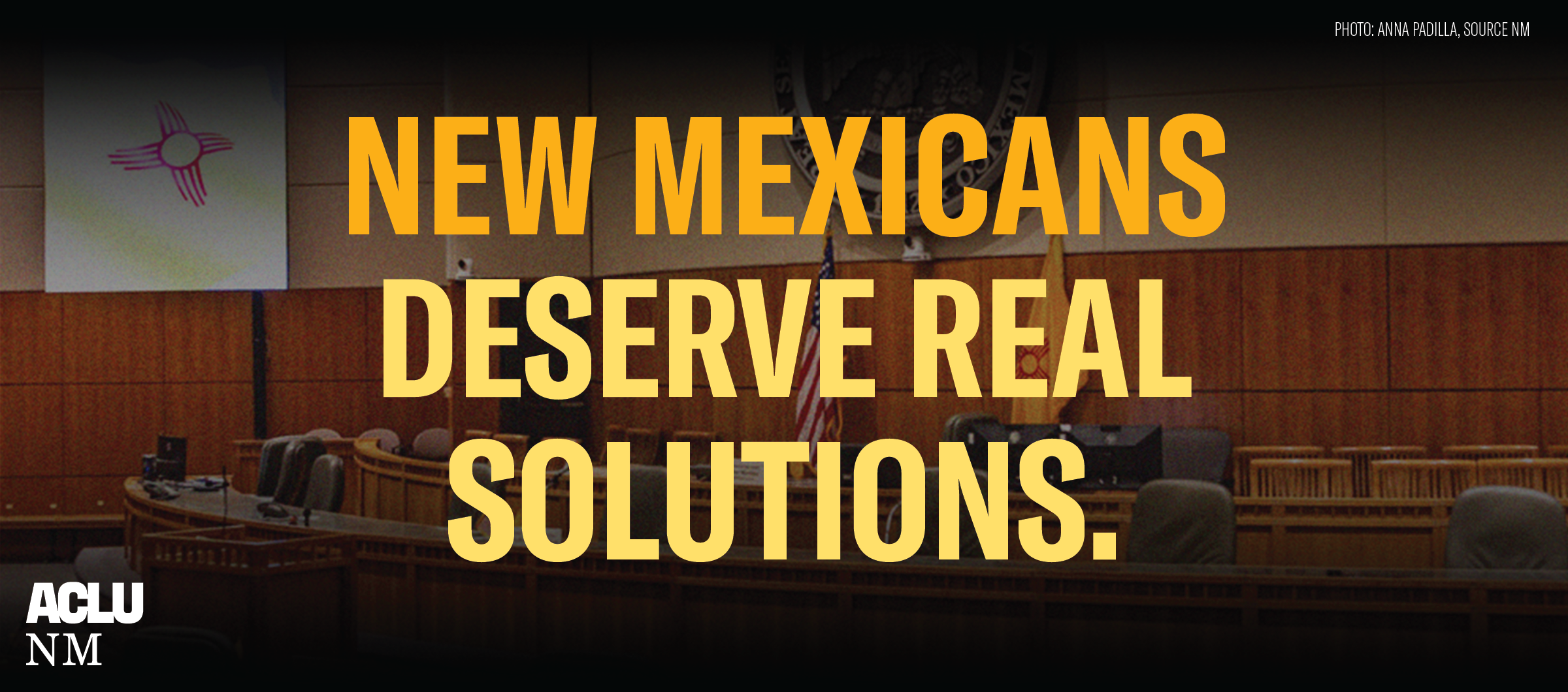 Banner image of the interior chamber of the Roundhouse with yellow text over it that reads: New Mexicans Deserve Real Solutions