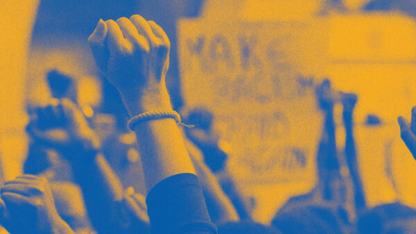 Stylized image of raised fists at a protest or rally.