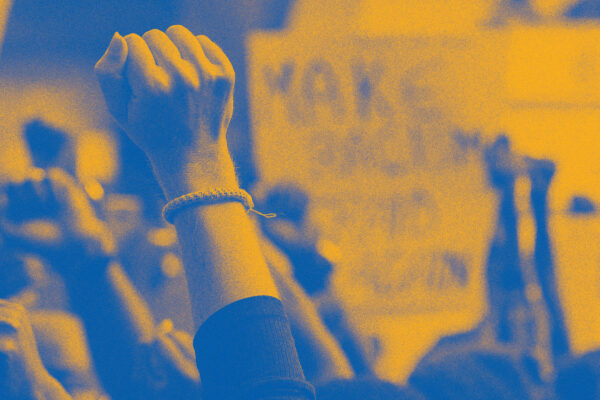 Stylized image of raised fists at a protest or rally.