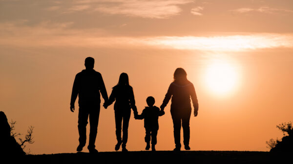 Image of a family backlit by the sunset