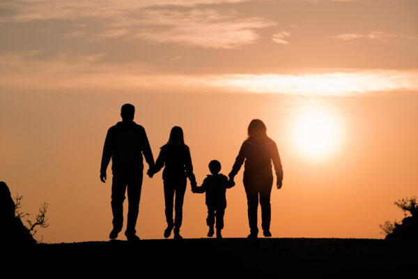 Image of a family backlit by the sunset