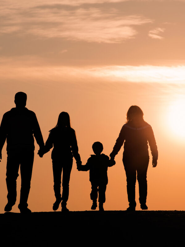 Image of a family backlit by the sunset