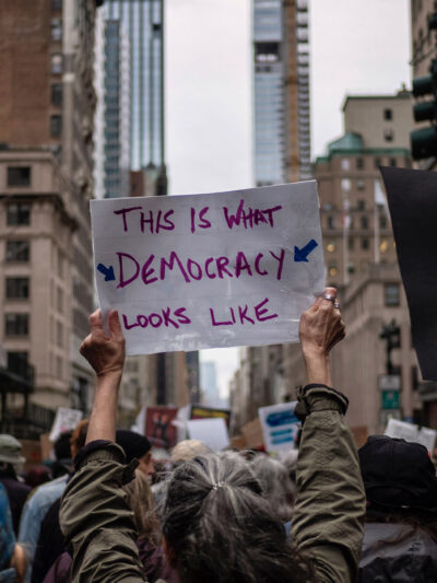 A group of demonstrators in Manhattan holding pro-democracy signage.