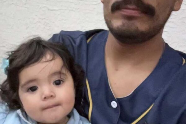 Image of Juan holding his daughter
