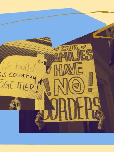 Two signs that read "We build this country together" and "our families have no borders"