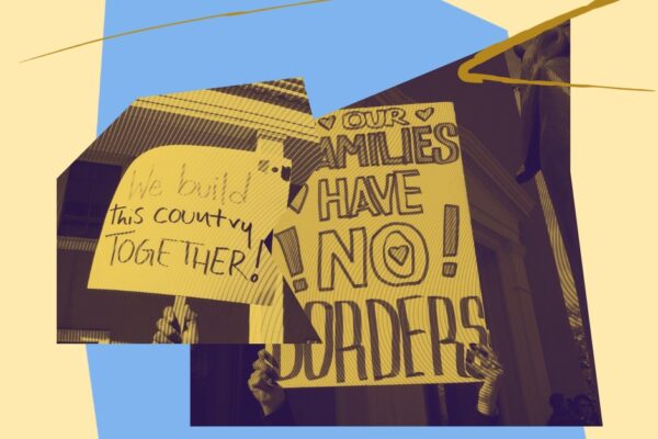 Two signs that read "We build this country together" and "our families have no borders"