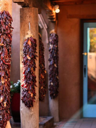 A house with ristras hanging on the porch in New Mexico.