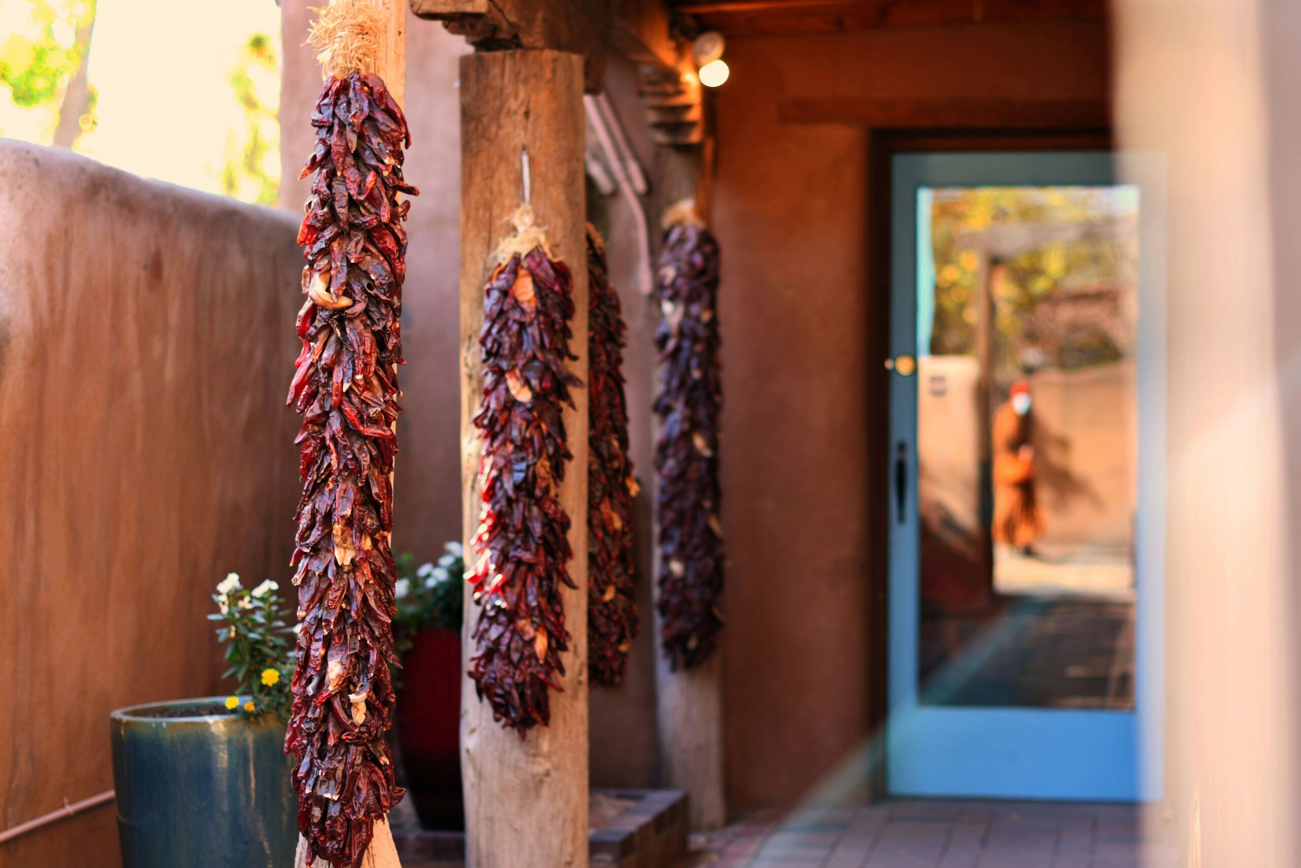 A house with ristras hanging on the porch in New Mexico.