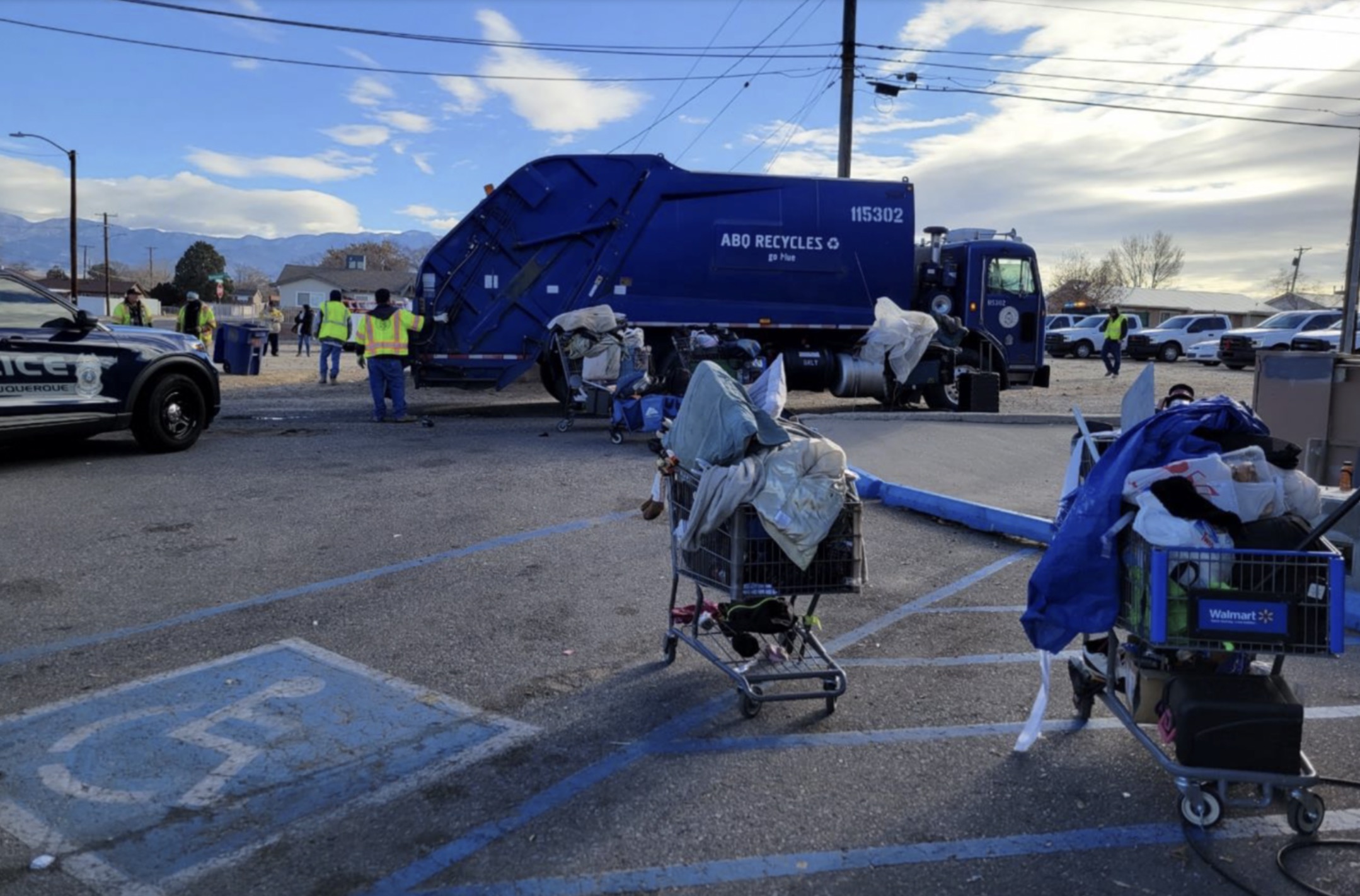City workers remove the personal belongings of unhoused people in Albuquerque, which a judge recently ruled unconstitutional.