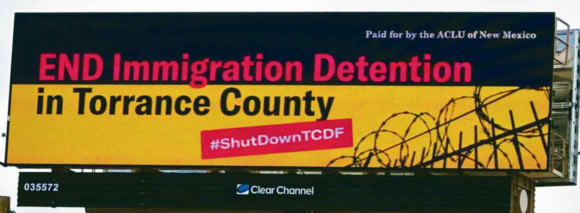 A billboard that reads "End Immigration Detention in Torrance County"