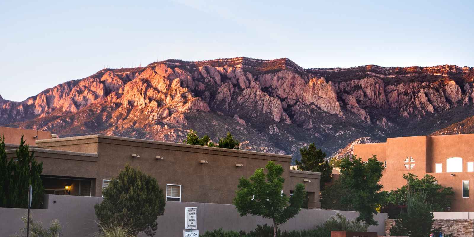 A photo of an Albuquerque neighborhood with the Sandia Mountains in the distance.