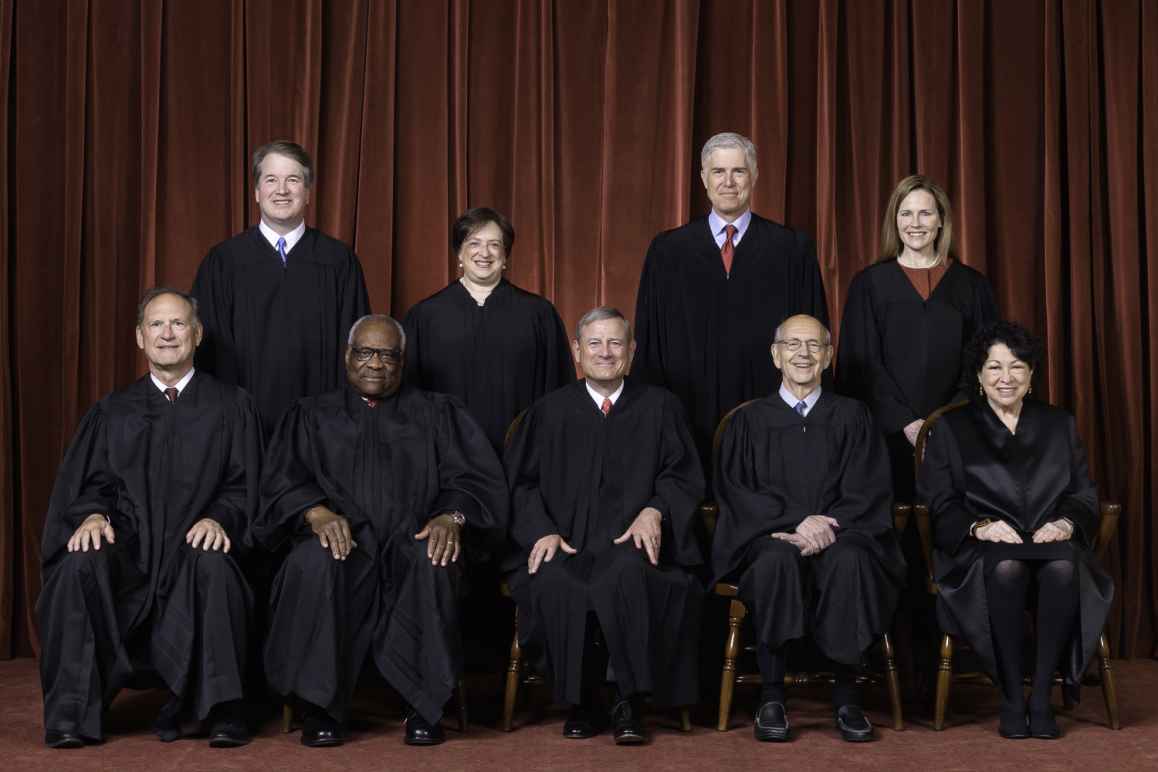 Photo of the Supreme Court Justices in black robes as composed October 27, 2020.