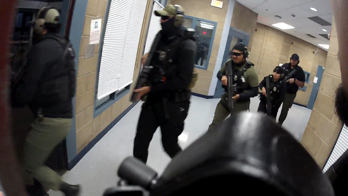 Body cam footage of training operations at DACDC, showing over five officers running into cells armed and masked.