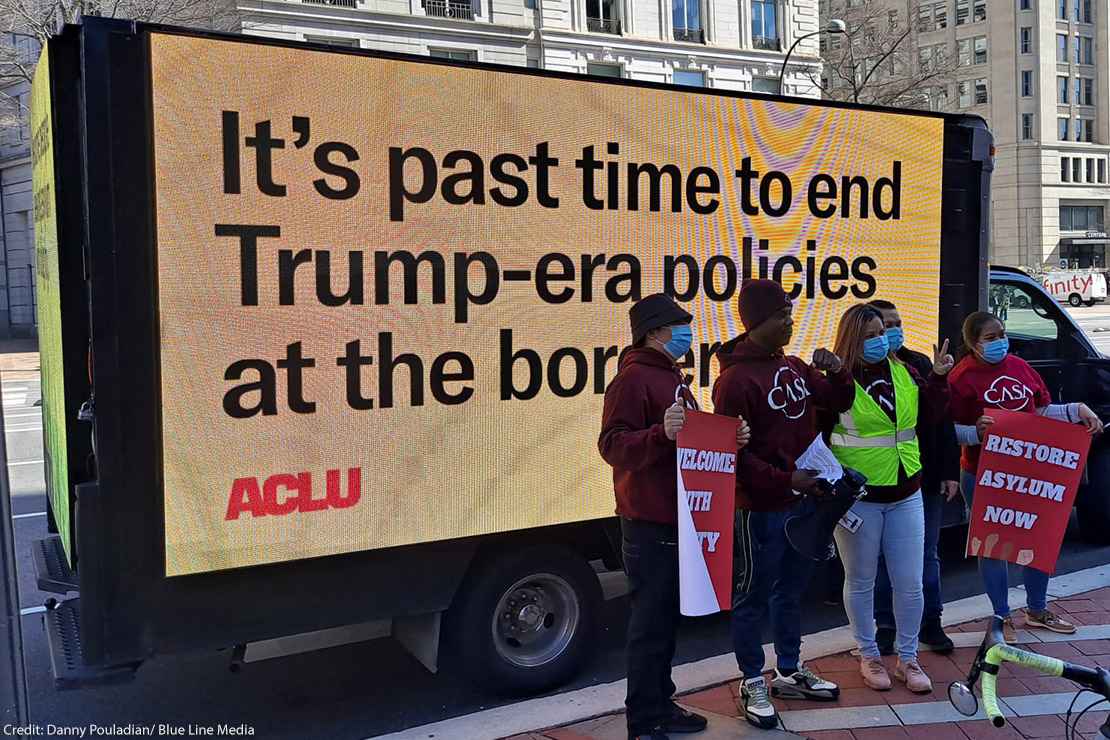Billboard saying "It's past time to end the Trump-era policies at the border"