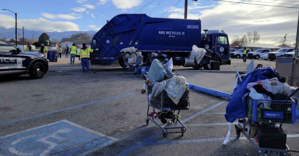 City workers remove the personal belongings of unhoused people in Albuquerque, which a judge recently ruled unconstitutional.