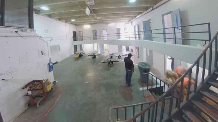 A prison guard watches as a person is assaulted in CNMCF. 