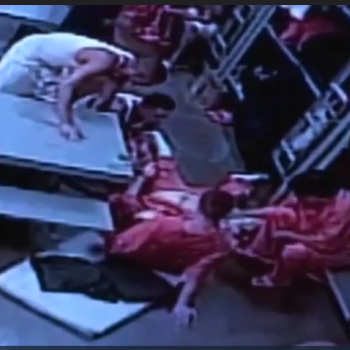 Fellow inmates tend to Douglas Edmisten as he lays on the ground in pain. This photo is a screen shot from the video released by KOB. Fellow inmates tend to Douglas Edmisten as he lays on the ground in pain.