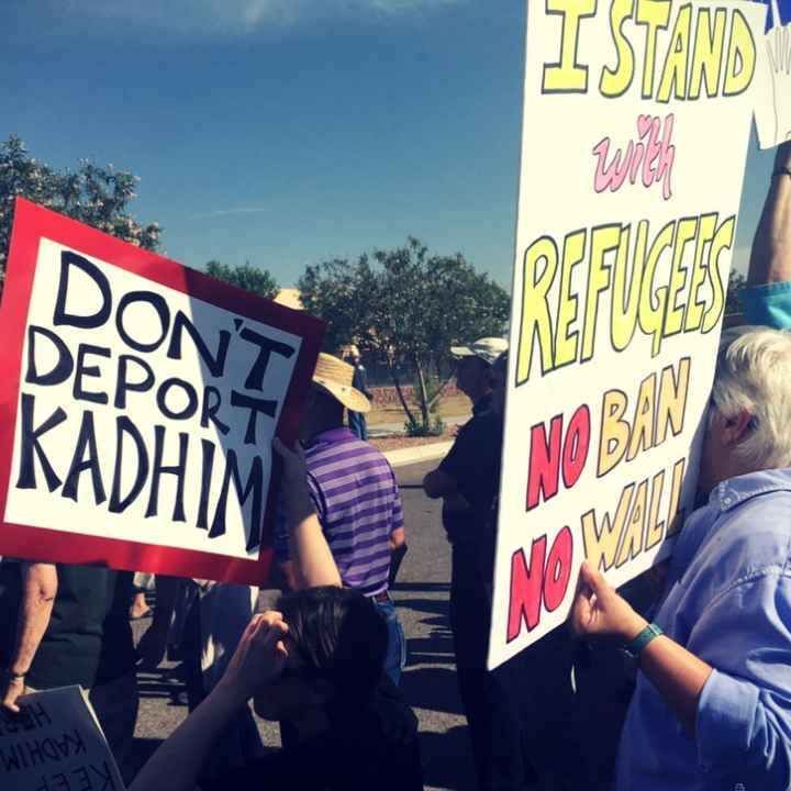 Supporters from Albuquerque gather to support Kadhim Al-bumohammed before his appointment with ICE officials Protesters hold posters that read "Don't deport Kadhim" and "I stand with refugees. No ban. No wall."