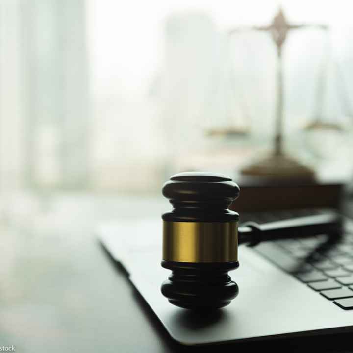 A gavel on a laptop.